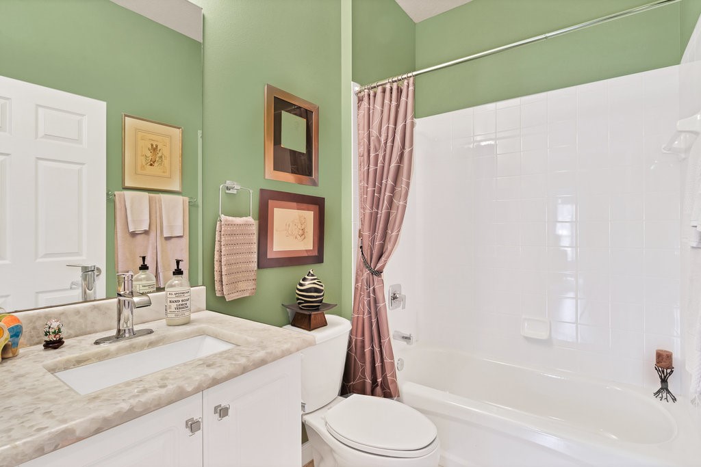 3812 Kitty Hawk Lane Southwest Vero Beach, FL 32968 - Photo 21 of 36 a bathroom with a granite countertop sink toilet and shower