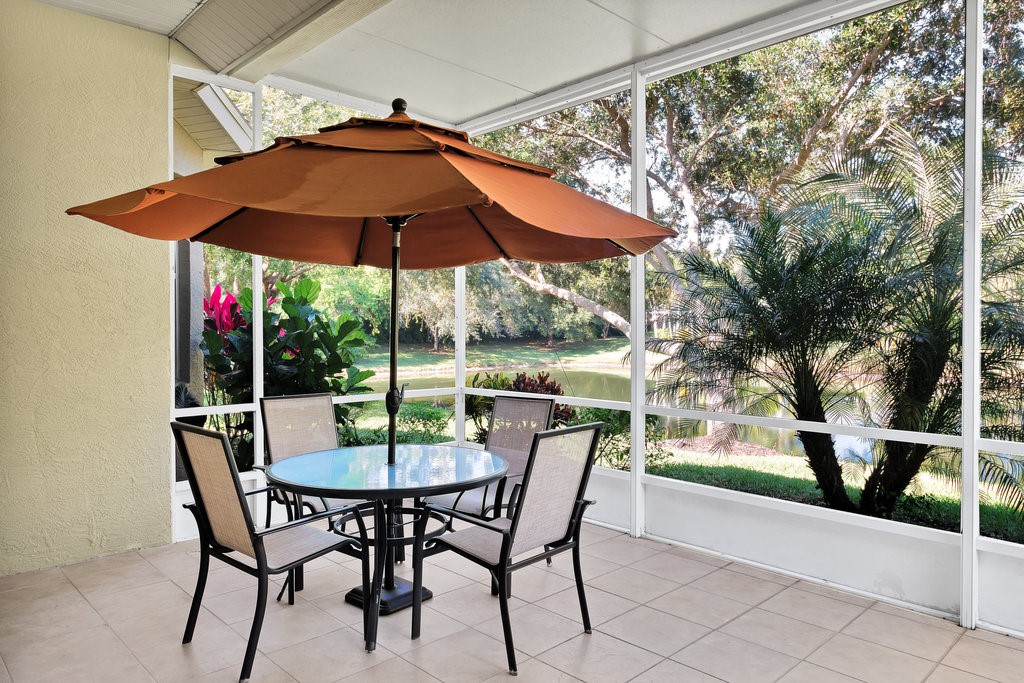 3812 Kitty Hawk Lane Southwest Vero Beach, FL 32968 - Photo 23 of 36 a view of a patio with table and chairs under an umbrella