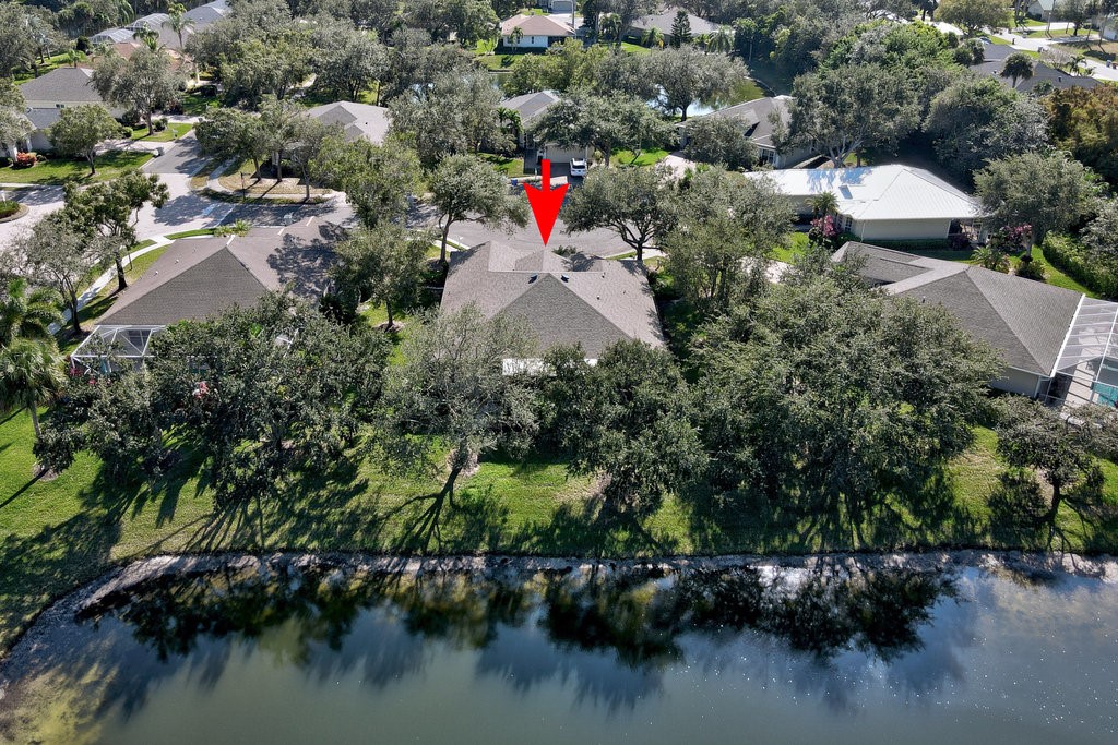 3812 Kitty Hawk Lane Southwest Vero Beach, FL 32968 - Photo 26 of 36 an aerial view of residential house with outdoor space and lake view
