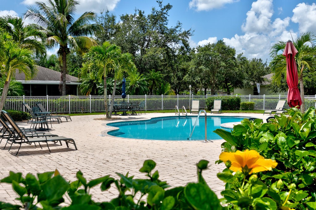 3812 Kitty Hawk Lane Southwest Vero Beach, FL 32968 - Photo 28 of 36 a view of a swimming pool with a patio and garden
