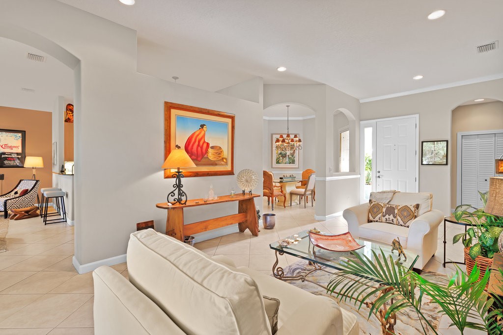 3812 Kitty Hawk Lane Southwest Vero Beach, FL 32968 - Photo 3 of 36 a living room with furniture and wall paintings