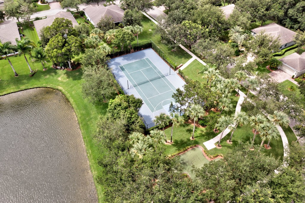 3812 Kitty Hawk Lane Southwest Vero Beach, FL 32968 - Photo 33 of 36 a aerial view of a house with a yard and large trees