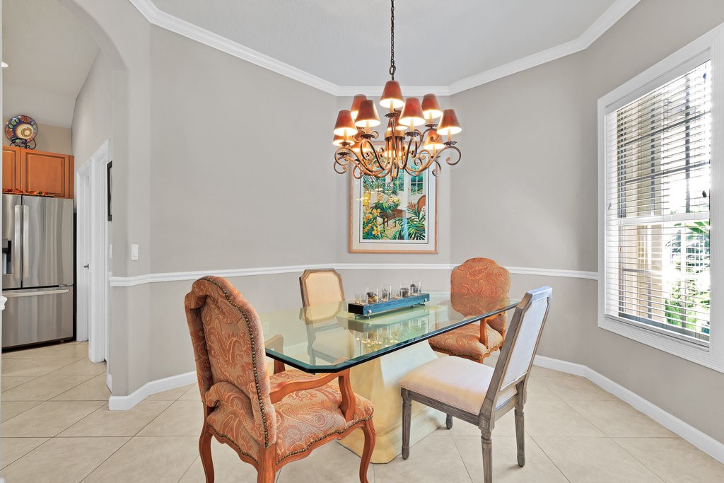 3812 Kitty Hawk Lane Southwest Vero Beach, FL 32968 - Photo 5 of 36 a dining room filled chandelier and furniture