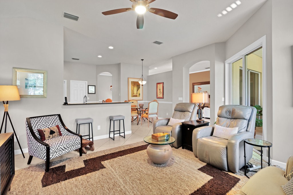 3812 Kitty Hawk Lane Southwest Vero Beach, FL 32968 - Photo 10 of 36 a living room with furniture and a large window