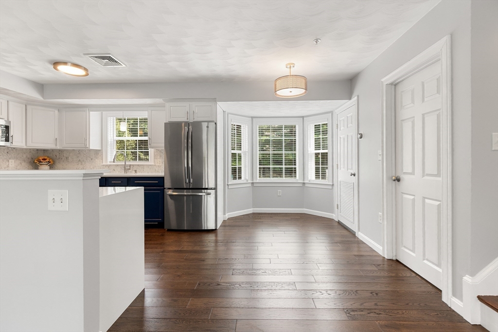 2 Ricciuti Drive, Unit 9 Quincy, MA 02169 - Photo 9 of 40 a kitchen with stainless steel appliances granite countertop a refrigerator and a stove top oven