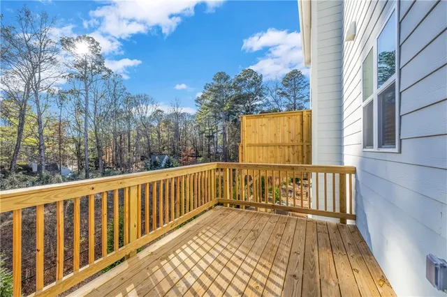 a view of balcony with wooden floor and fence