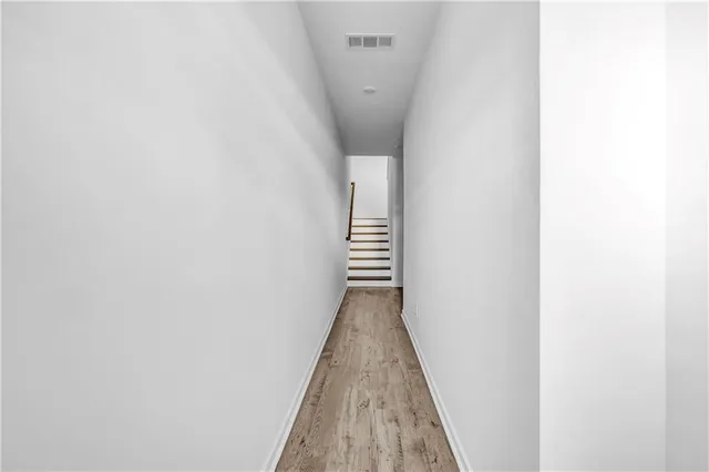 a view of a hallway with stairs
