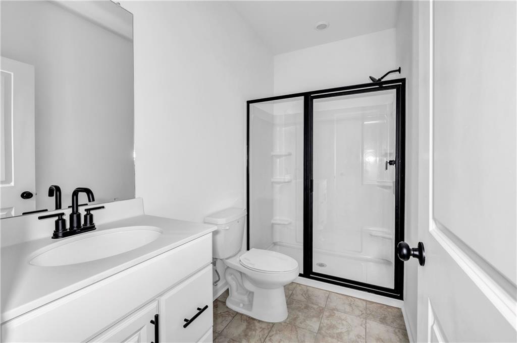 5772 Schelton Place Mableton, GA 30126 - Photo 5 of 24 a bathroom with a sink toilet and shower