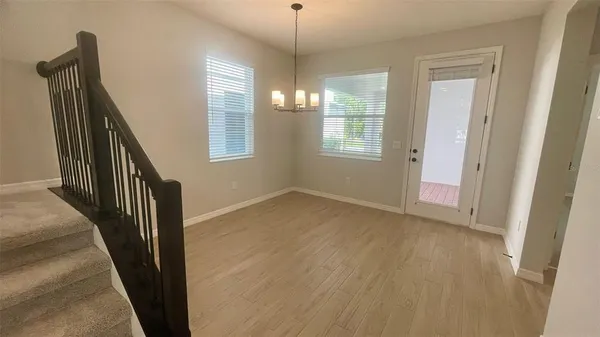 a view of an entryway with wooden floor and stairs