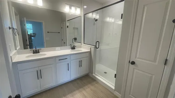 a spacious bathroom with a double vanity sink mirror and double