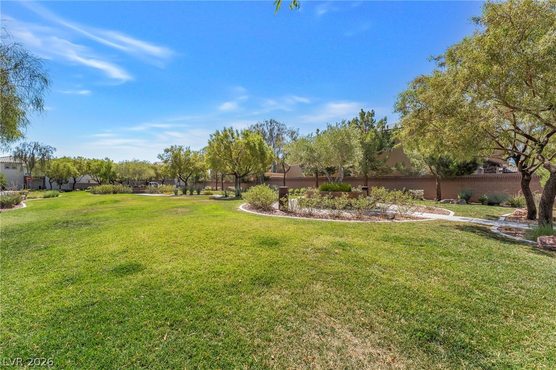 6245 Andover Wood Road Las Vegas, NV 89113 - Photo 36 of 37 Green open space with walking paths and vibrant plantings awaits exploration.