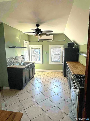 a kitchen with stainless steel appliances granite countertop a stove a sink dishwasher and a refrigerator