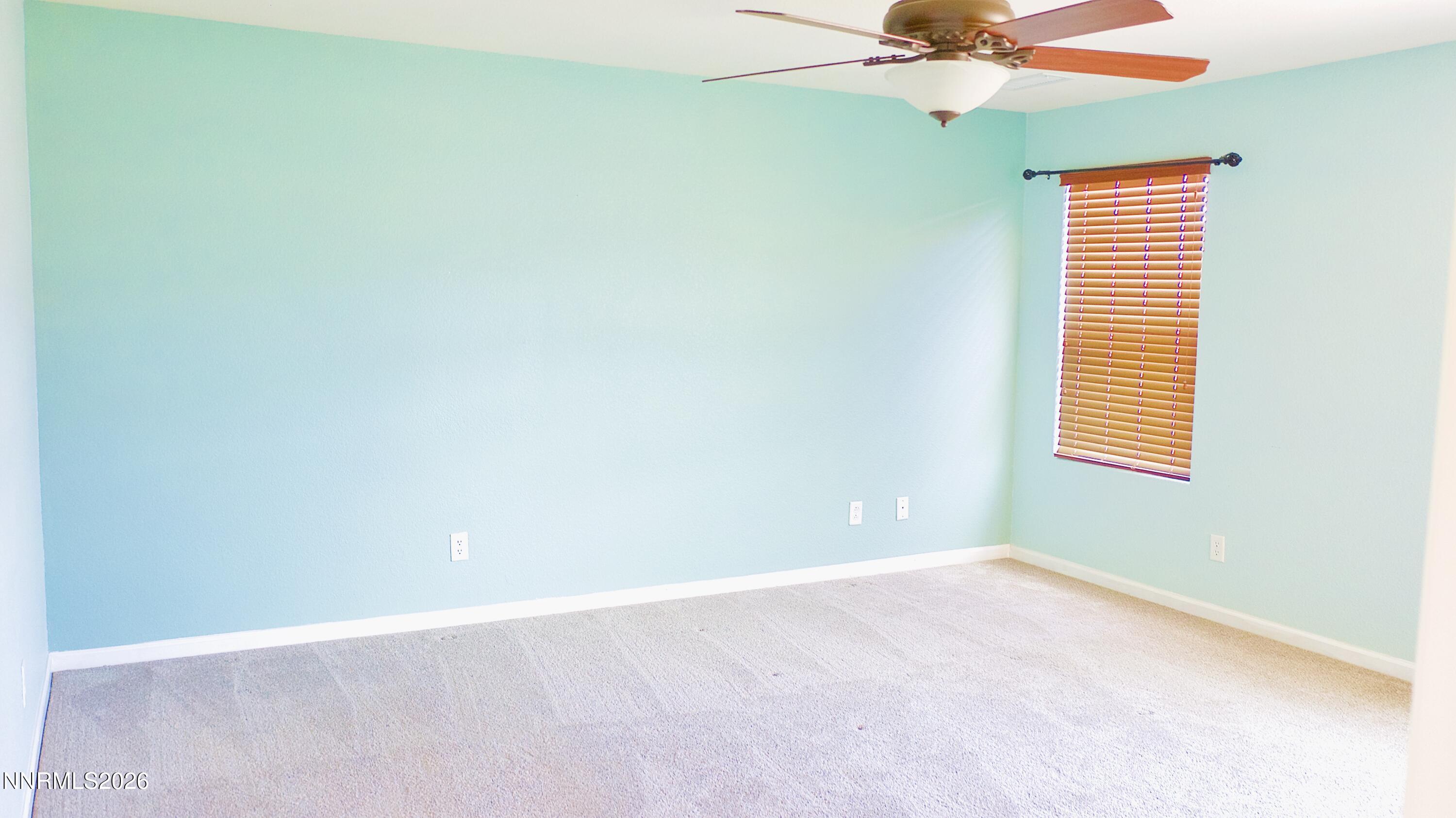11590 Rivolli Court Reno, NV 89521 - Photo 14 of 22 an empty room with a window and a ceiling fan