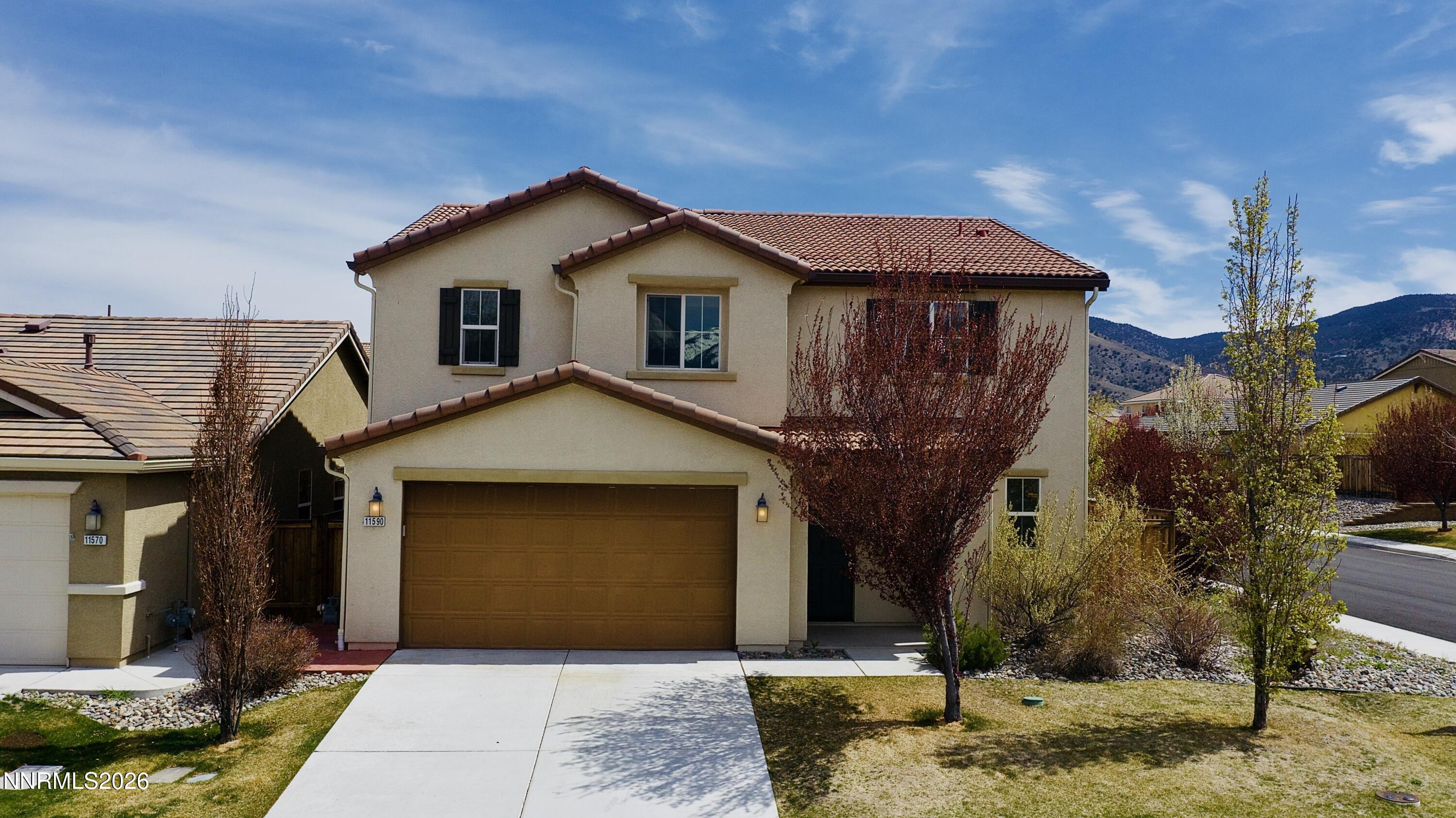 11590 Rivolli Court Reno, NV 89521 - Photo 2 of 22 a front view of a house with a yard