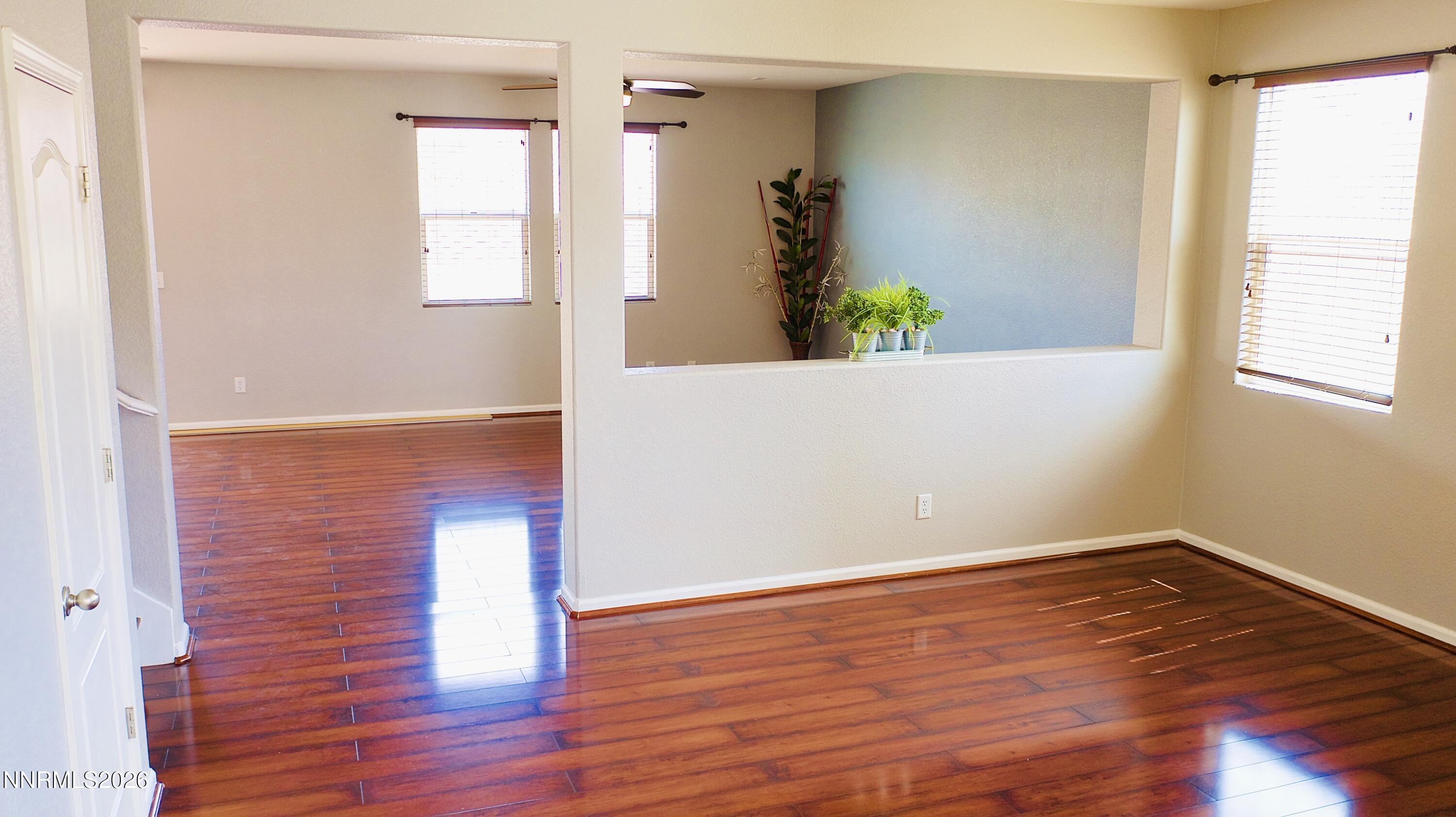 11590 Rivolli Court Reno, NV 89521 - Photo 5 of 22 a view of empty room with wooden floor and fan