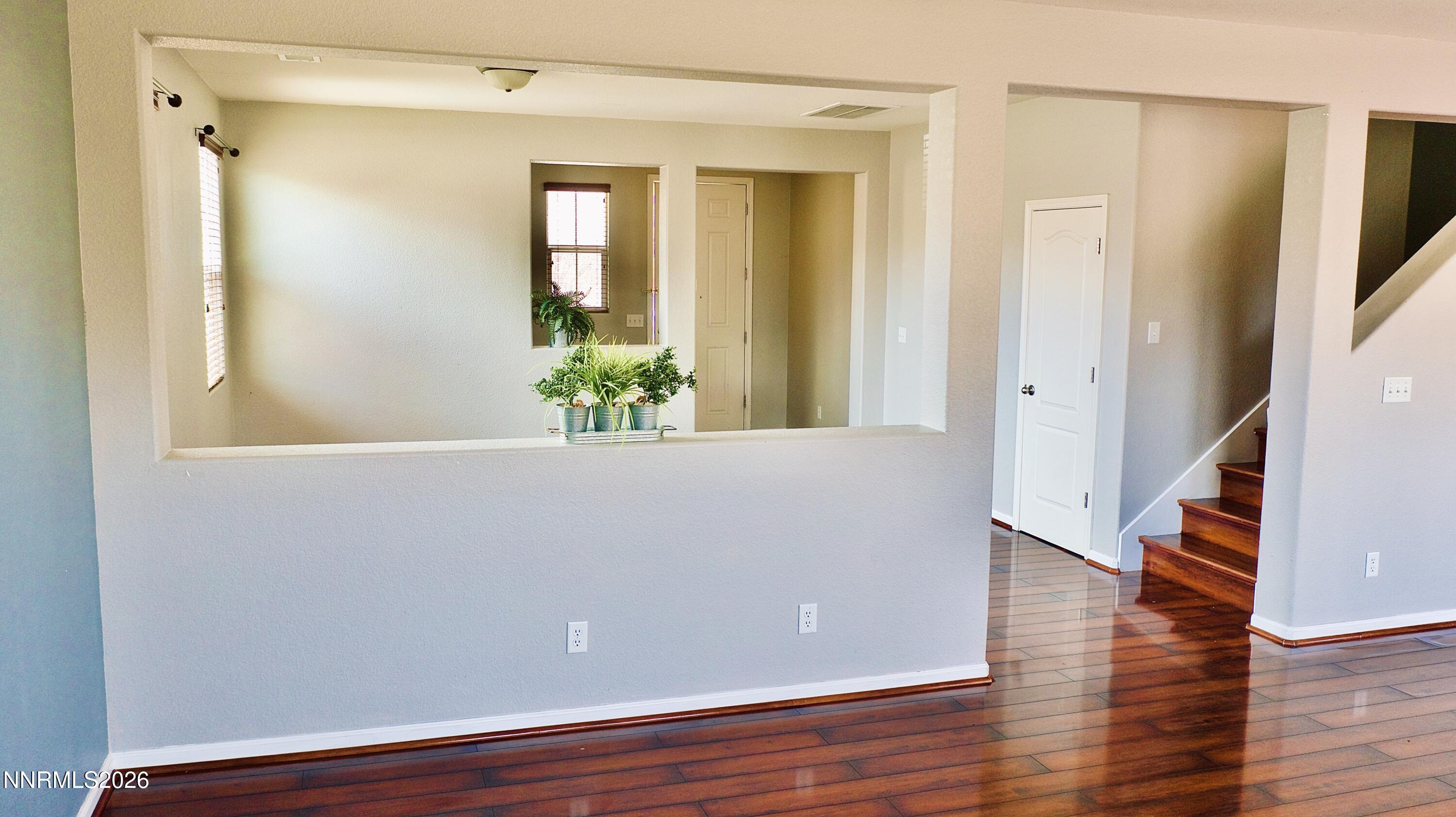 11590 Rivolli Court Reno, NV 89521 - Photo 7 of 22 a view of an empty room with wooden floor and a bathroom