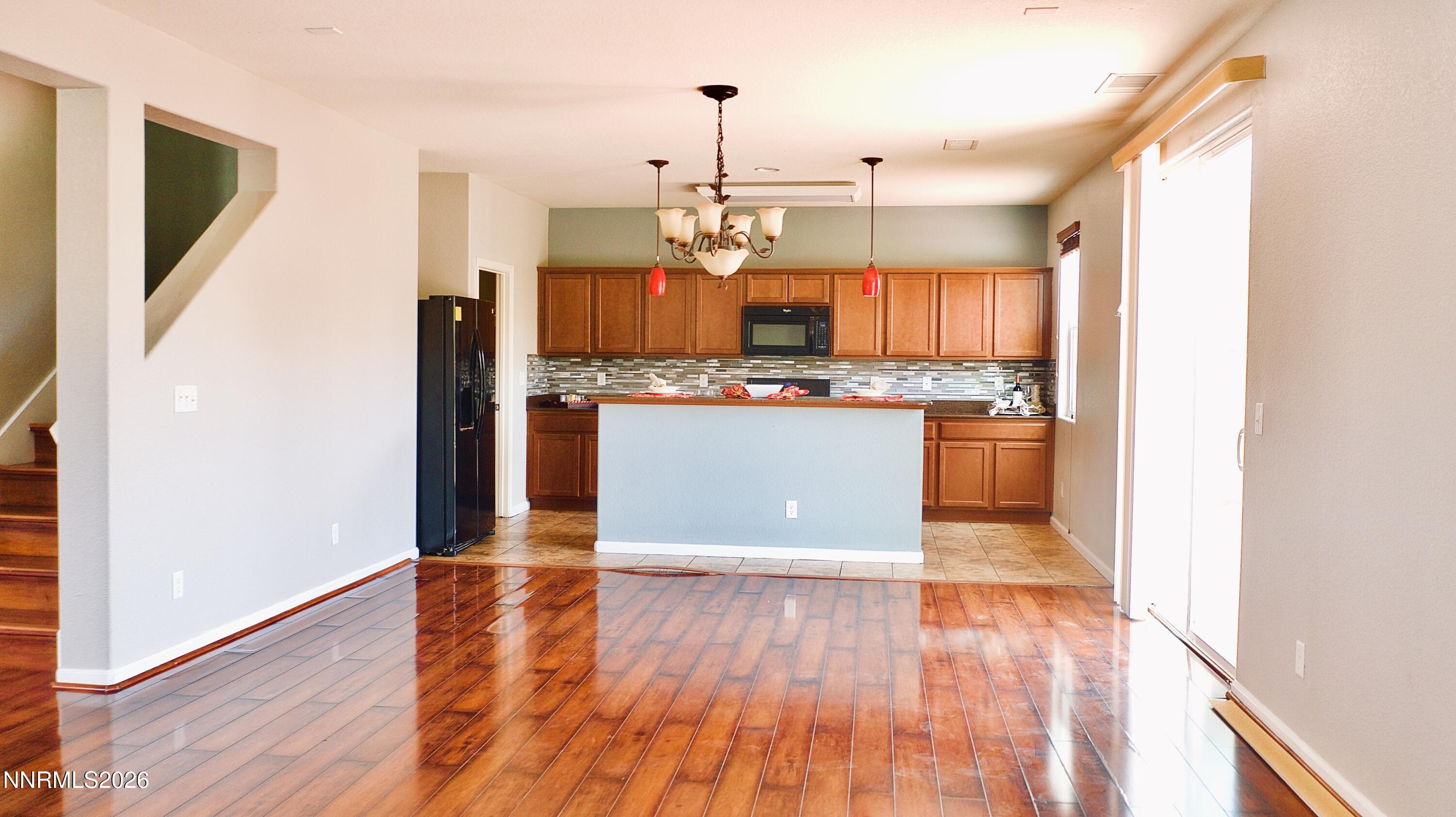 11590 Rivolli Court Reno, NV 89521 - Photo 8 of 22 a kitchen with stainless steel appliances granite countertop a stove top oven a sink and a refrigerator