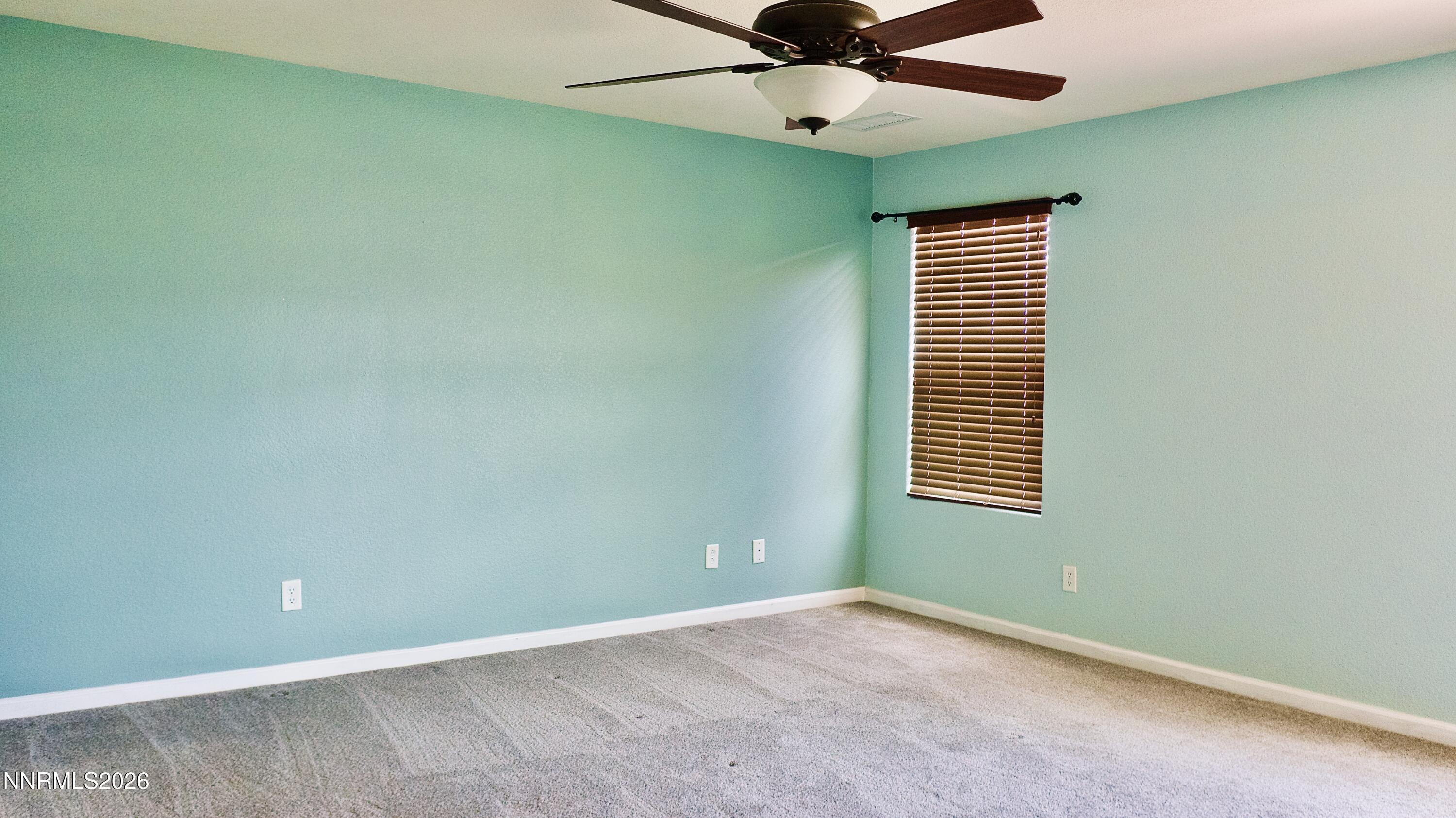 11590 Rivolli Court Reno, NV 89521 - Photo 9 of 22 an empty room with a window and a fan