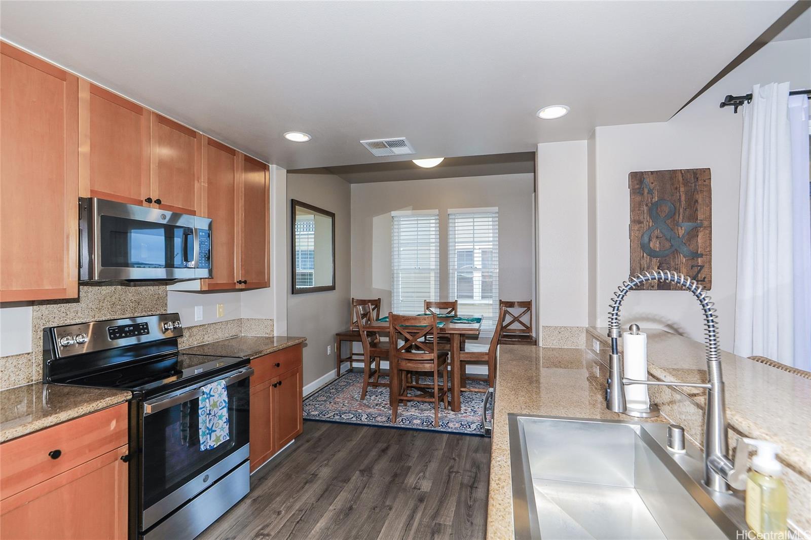 520 Lunalilo Home Road, Unit 6214 Honolulu, HI 96825 - Photo 3 of 25 a kitchen with stainless steel appliances granite countertop sink stove top oven and cabinets