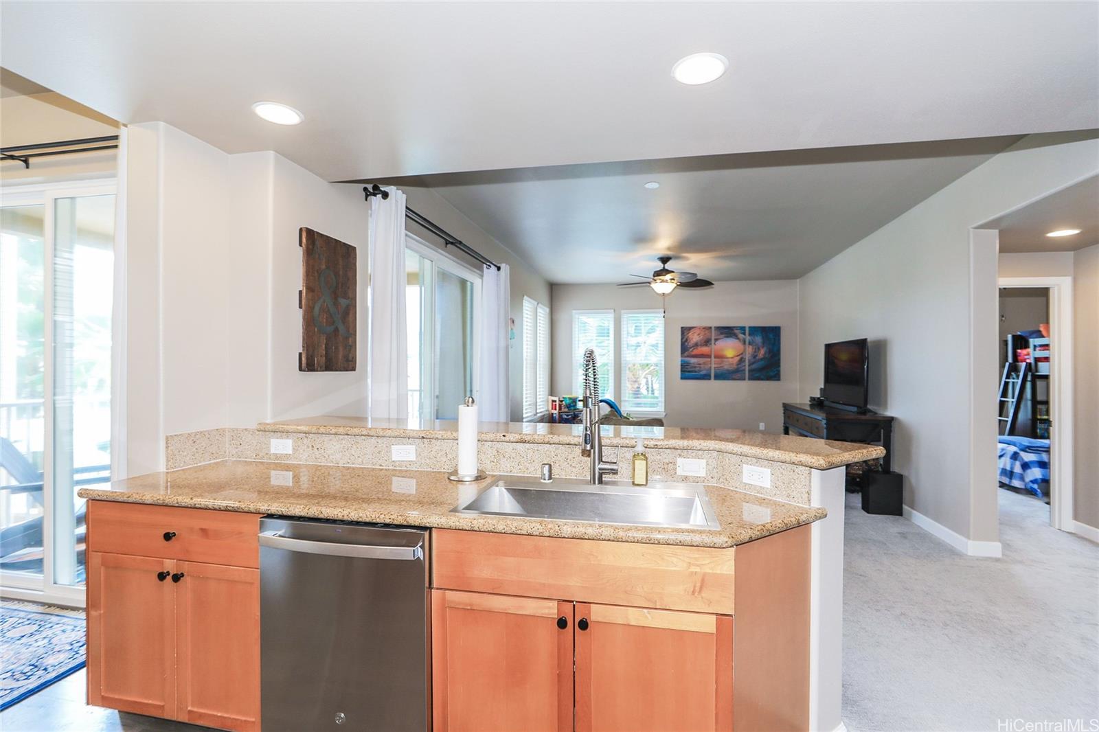 520 Lunalilo Home Road, Unit 6214 Honolulu, HI 96825 - Photo 4 of 25 a kitchen with kitchen island granite countertop a sink and a refrigerator