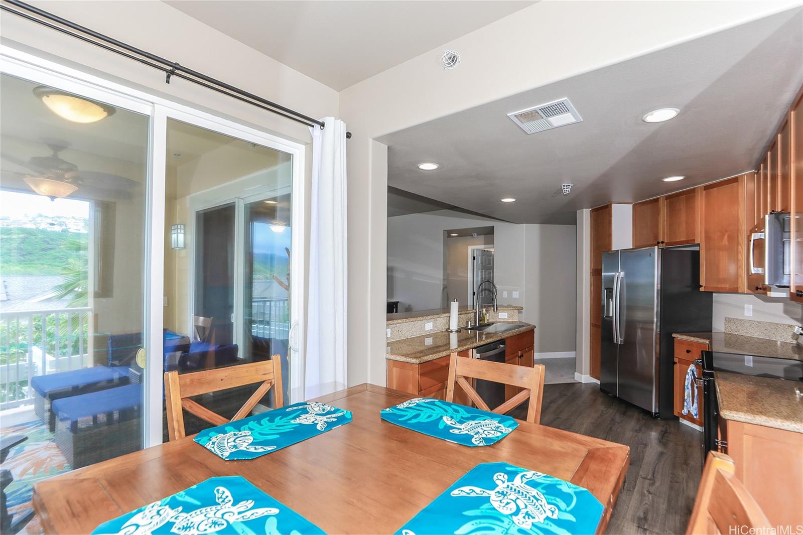 520 Lunalilo Home Road, Unit 6214 Honolulu, HI 96825 - Photo 6 of 25 a room with furniture a rug and a chandelier