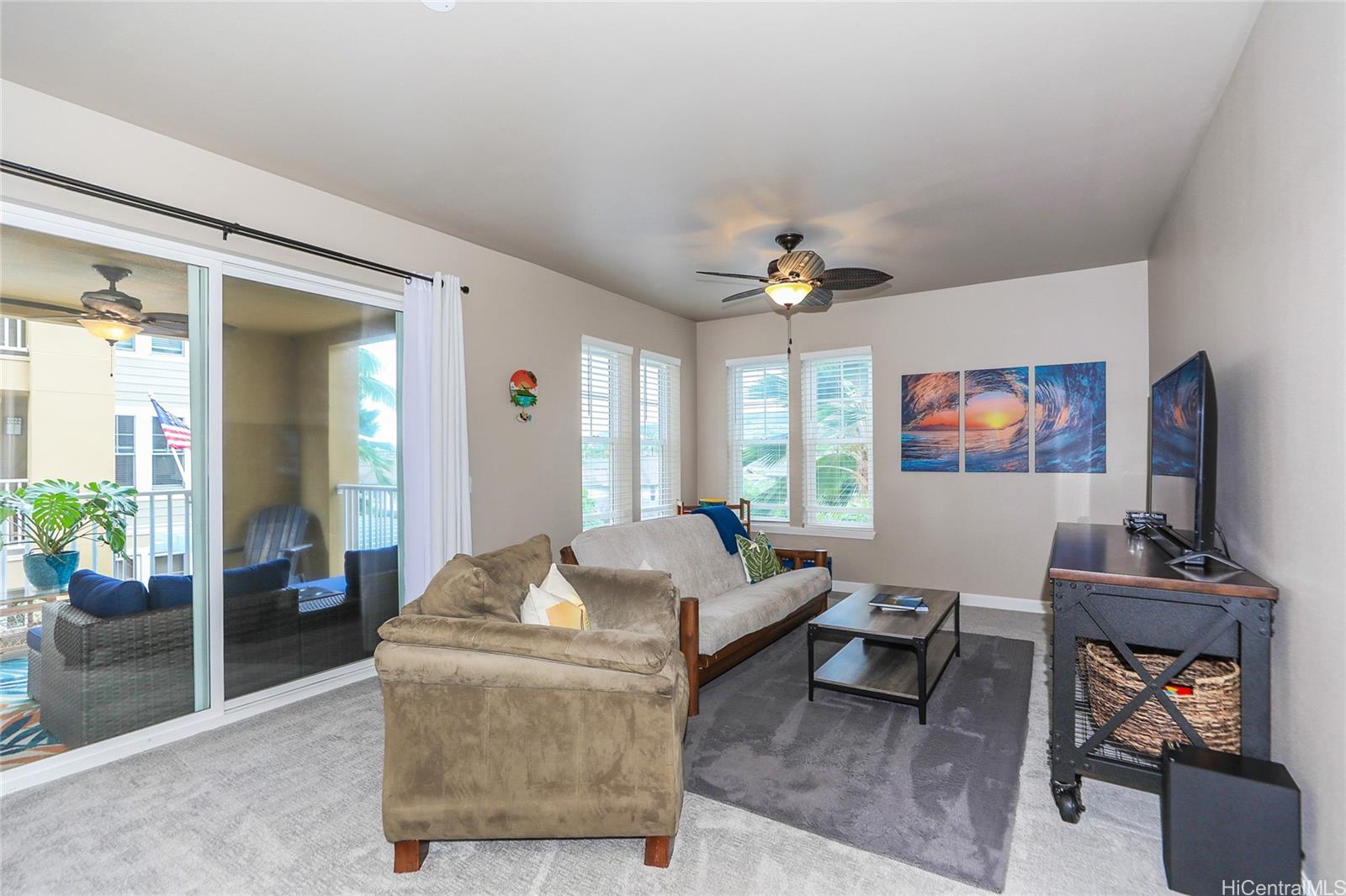 520 Lunalilo Home Road, Unit 6214 Honolulu, HI 96825 - Photo 8 of 25 a living room with furniture a chandelier and a flat screen tv