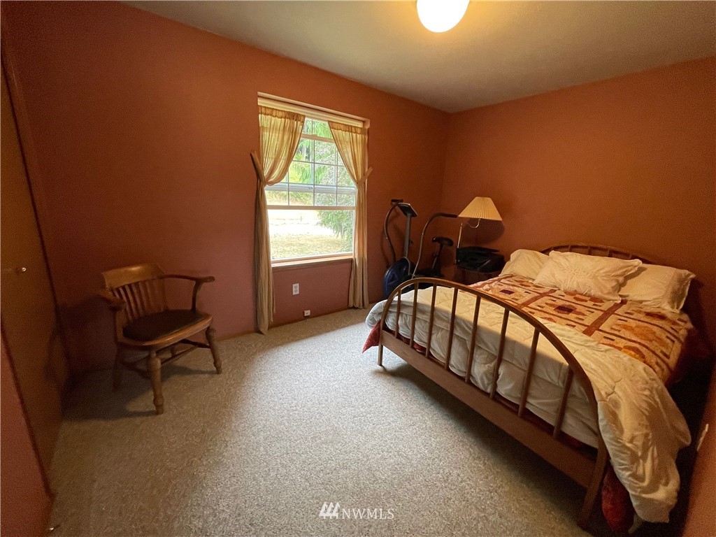 404 Independence Road Rochester, WA 98579 - Photo 32 of 40 a bedroom with a bed chair and a window