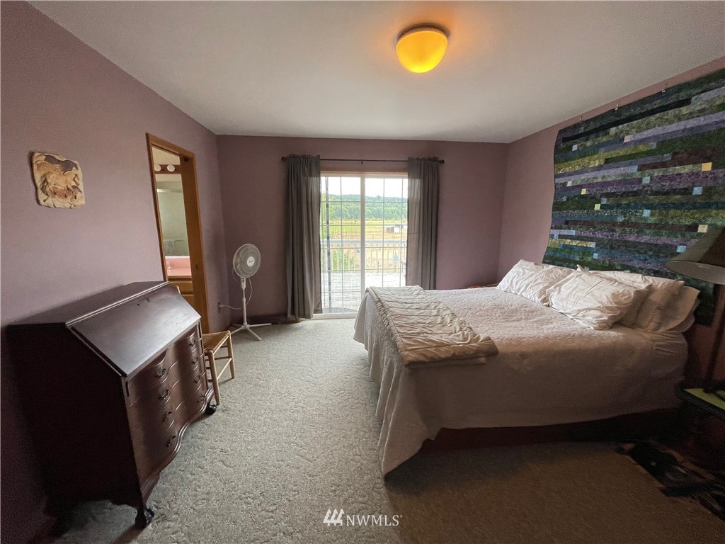 404 Independence Road Rochester, WA 98579 - Photo 34 of 40 a bedroom with a bed and large windows