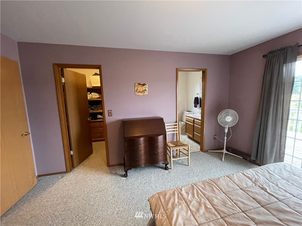 404 Independence Road Rochester, WA 98579 - Photo 35 of 40 a bedroom with a bed and a chair