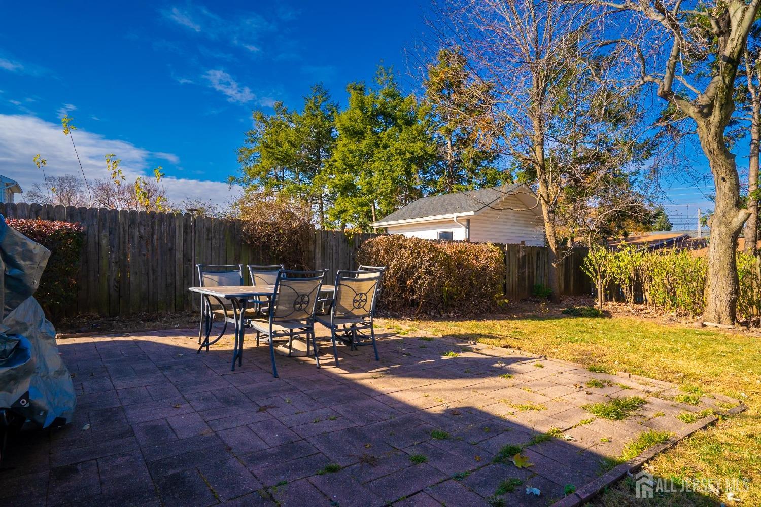 23 Winthrop Road Edison, NJ 08817 - Photo 21 of 29 a view of a patio with table and chairs with wooden fence and plants