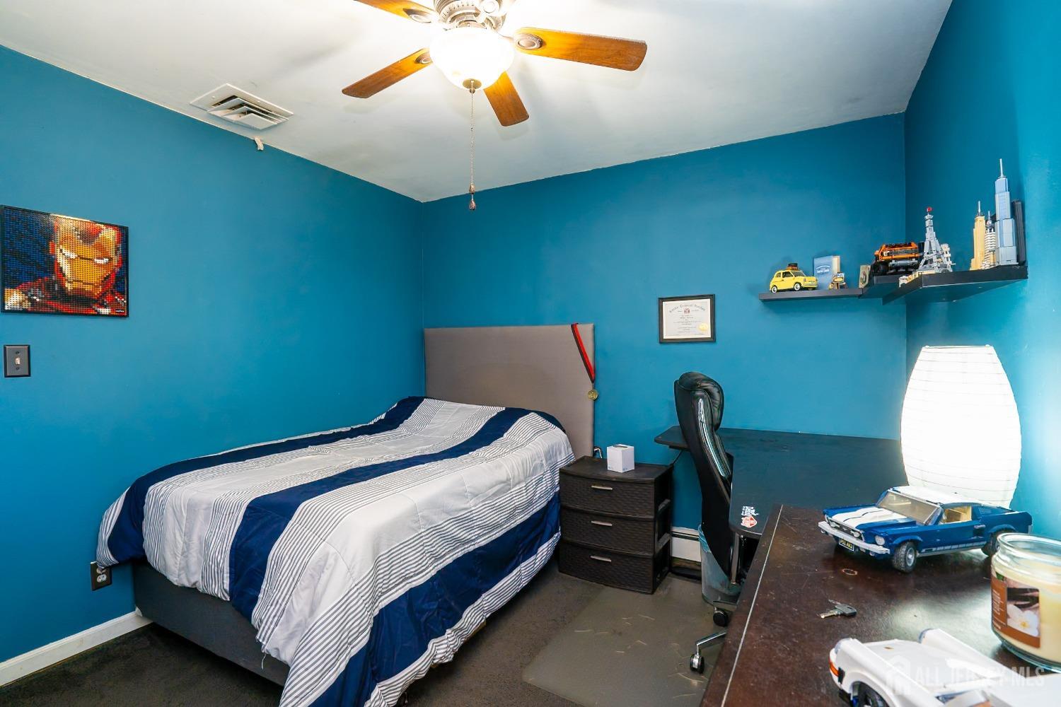 23 Winthrop Road Edison, NJ 08817 - Photo 23 of 29 a bedroom with a bed and a chandelier
