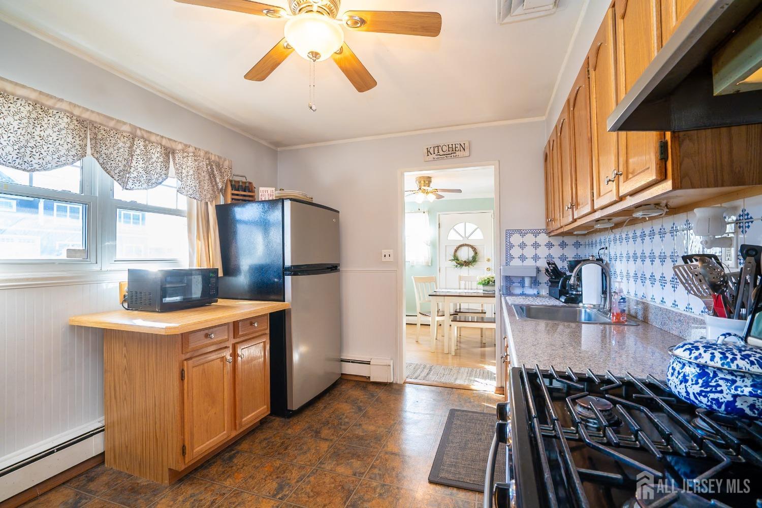 23 Winthrop Road Edison, NJ 08817 - Photo 26 of 29 a kitchen with a stove and a refrigerator