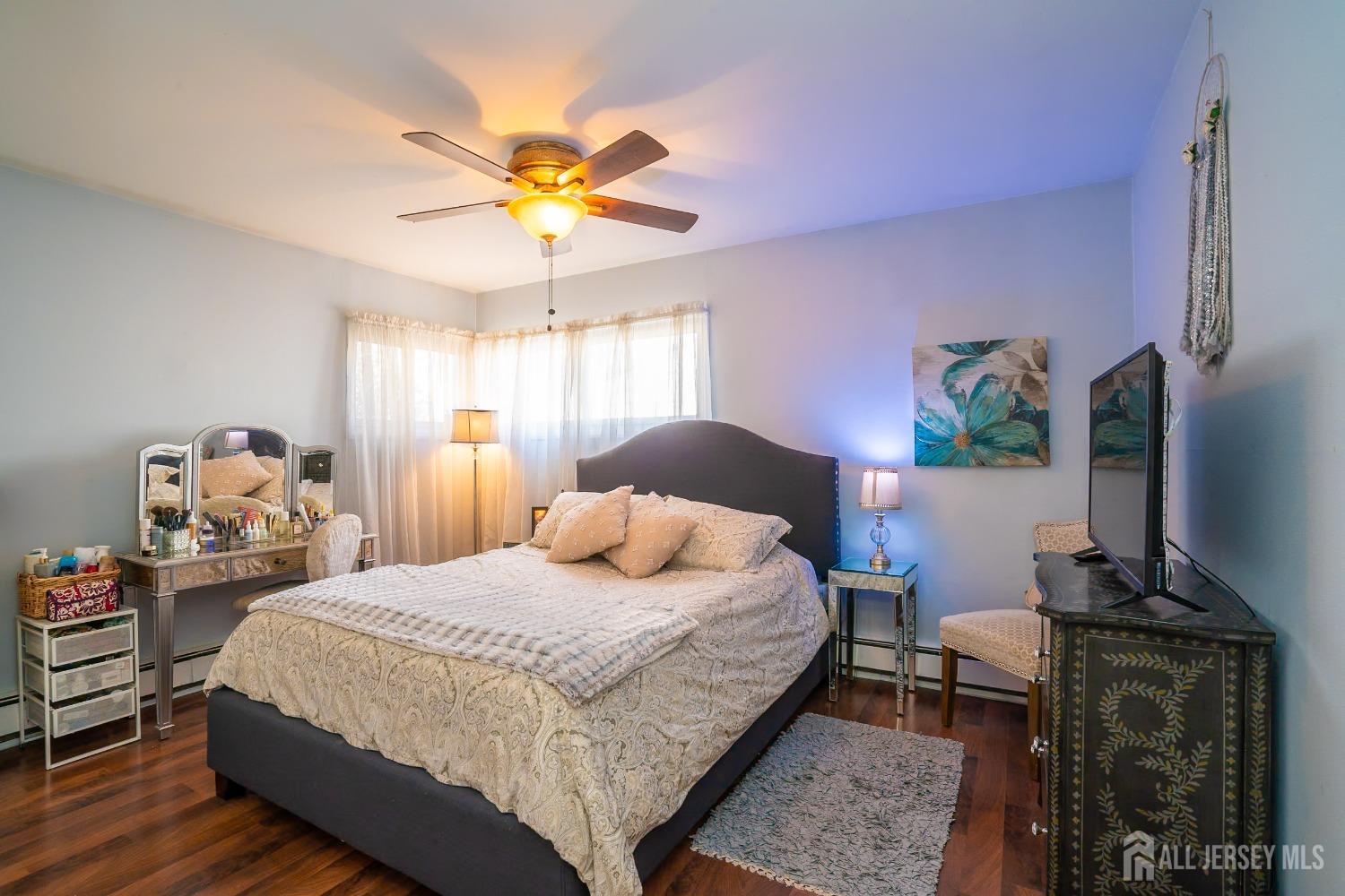23 Winthrop Road Edison, NJ 08817 - Photo 8 of 29 a bedroom with a bed and a flat tv screen on dresser