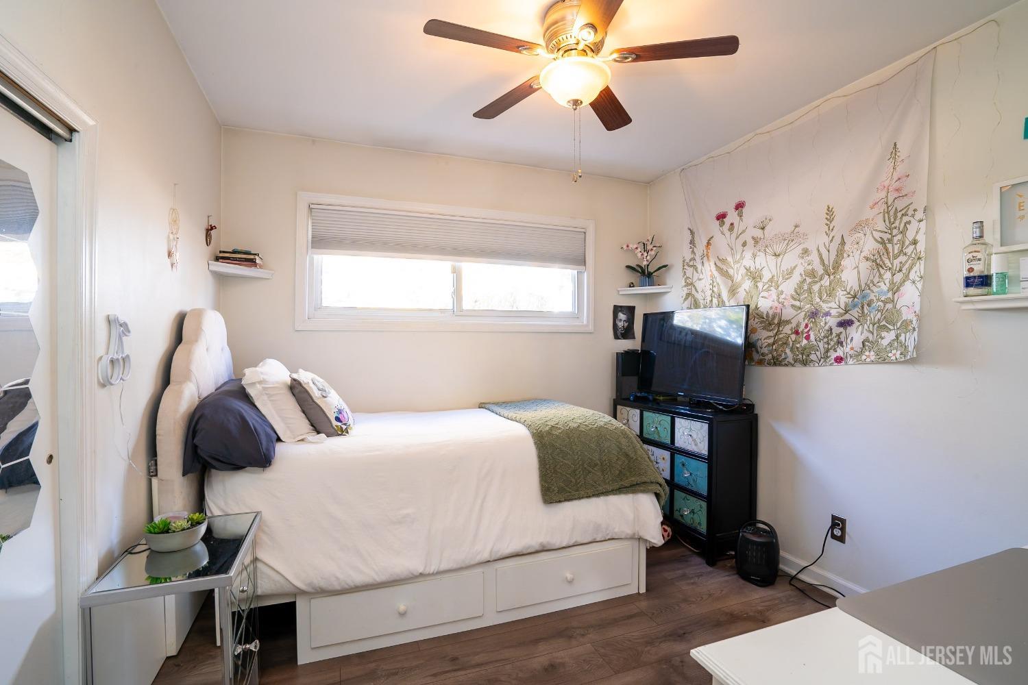 23 Winthrop Road Edison, NJ 08817 - Photo 10 of 29 a bedroom with a bed and a chandelier