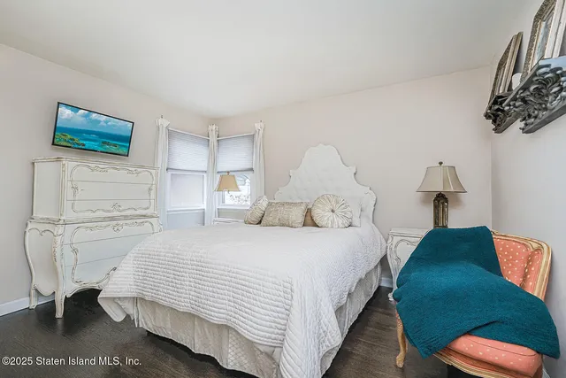 a bedroom with double bed and a window