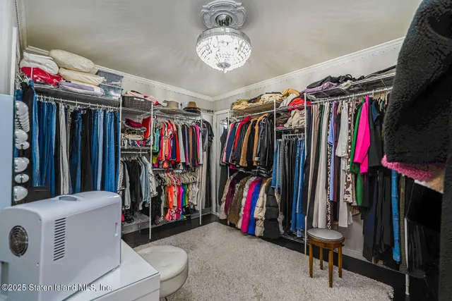 a view of walk in closet with clothes