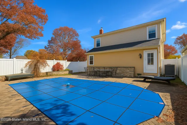 a view of a backyard with sitting area