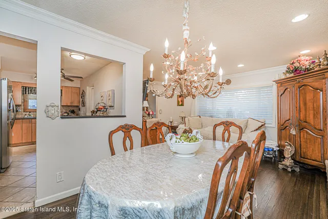 a view of a dining room with furniture and chandelier