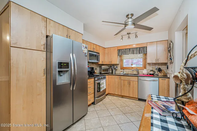 a kitchen with a refrigerator a sink and cabinets