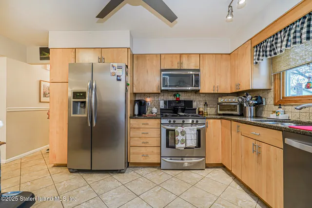 a kitchen with stainless steel appliances a refrigerator sink and microwave