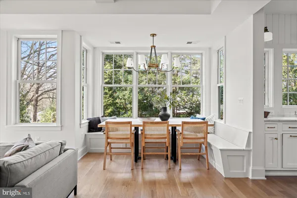 a view of an empty room with a window and front door