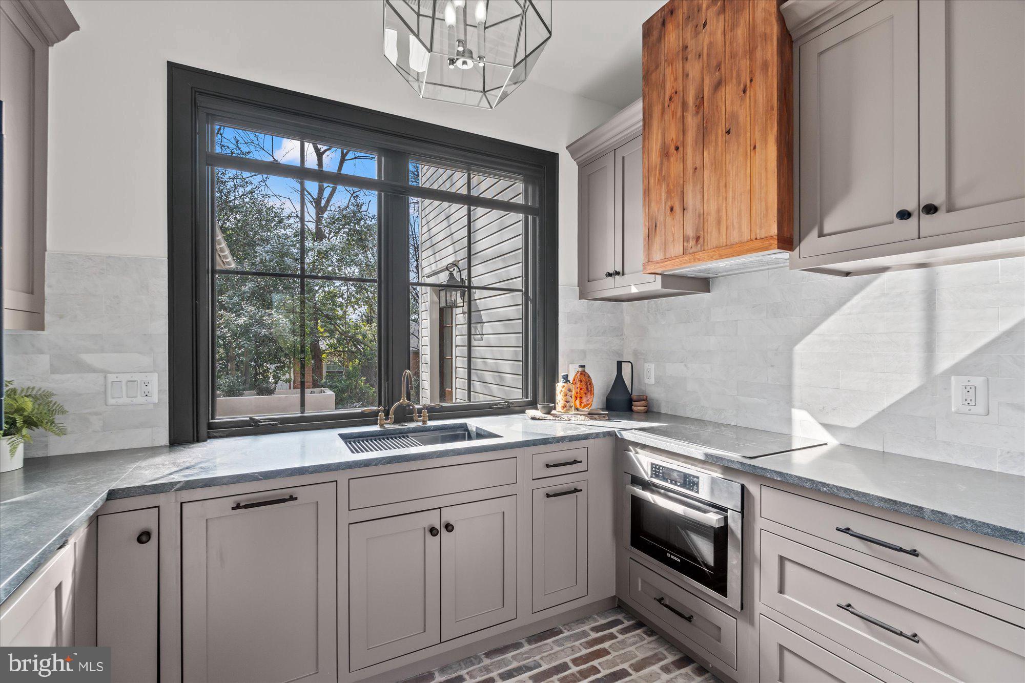 3612 North Glebe Road Arlington, VA 22207 - Photo 34 of 83 a kitchen with stainless steel appliances white cabinets and a window