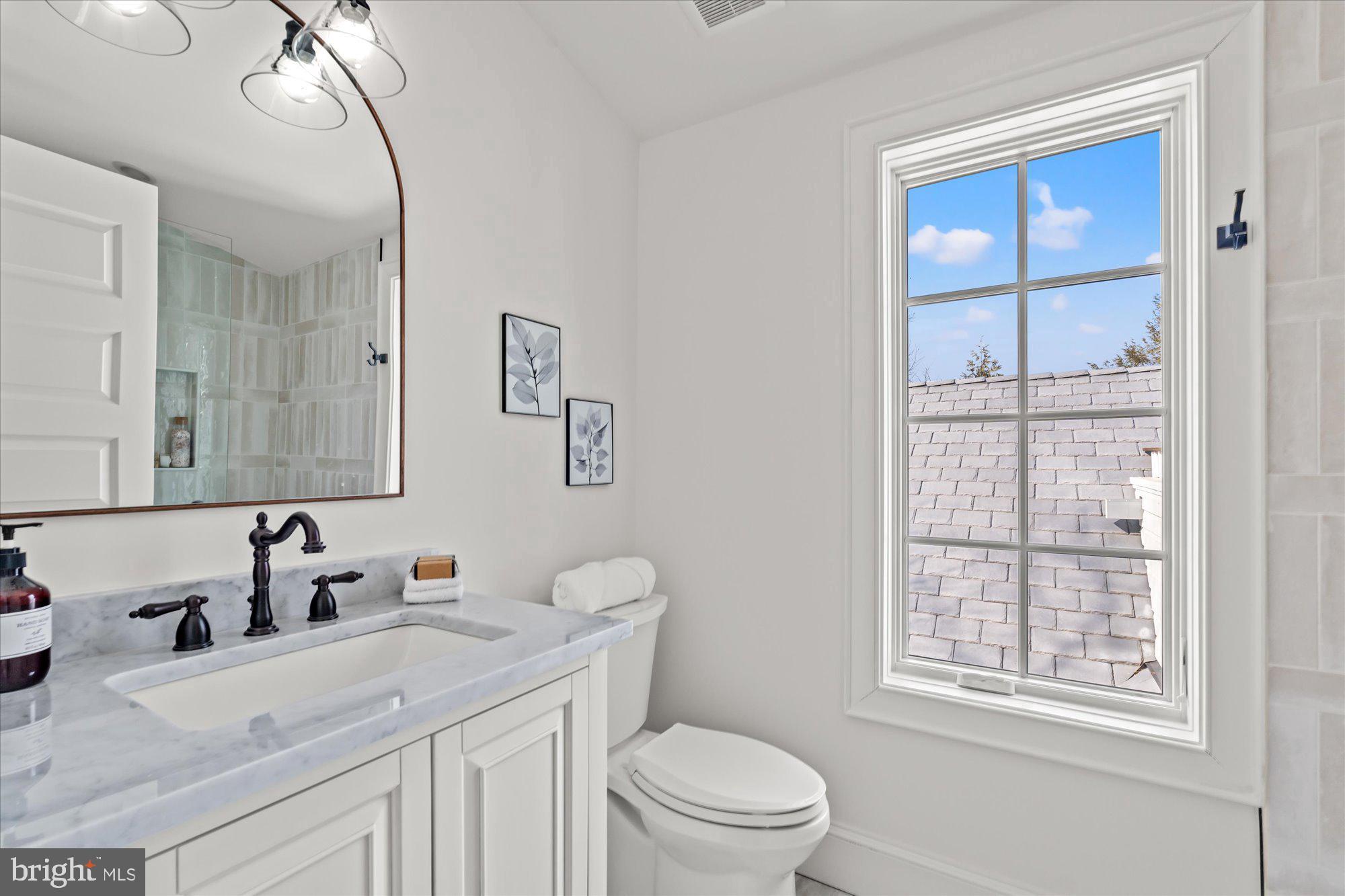 3612 North Glebe Road Arlington, VA 22207 - Photo 68 of 83 a bathroom with a sink vanity granite toilet and a mirror
