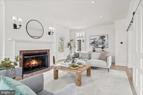 a living room with furniture a fireplace and wooden floor