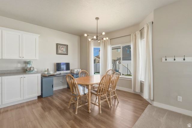 836 South 250 West Vernal, UT 84078 - Photo 26 of 56 Dining space featuring light wood-style flooring and a chandelier