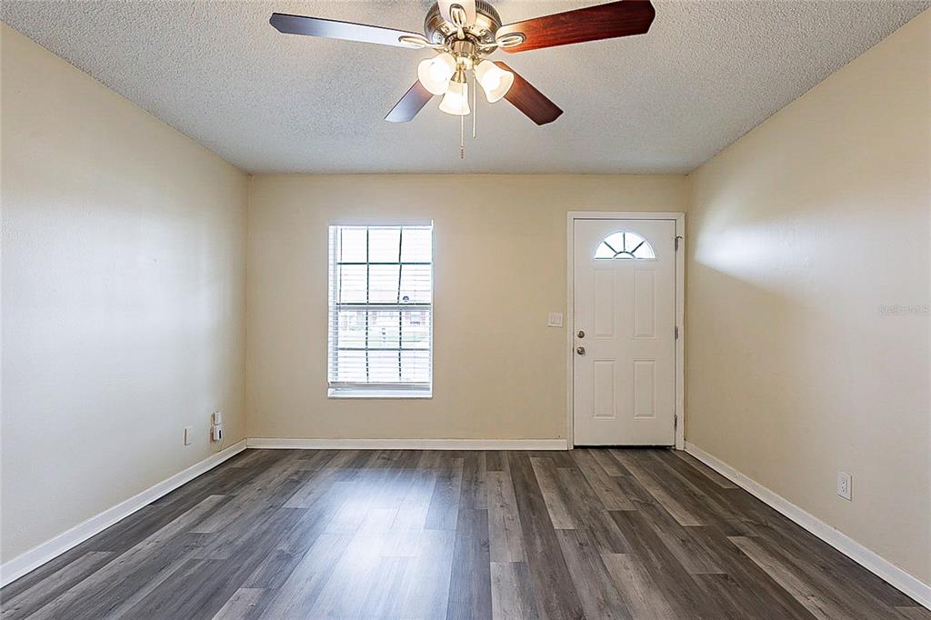 8528 Gold Ridge Circle Tampa, FL 33619 - Photo 2 of 31 wooden floor in an empty room with a window