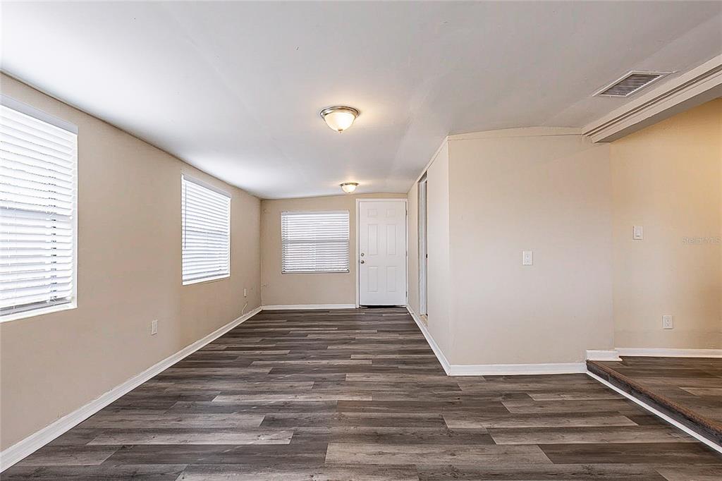 8528 Gold Ridge Circle Tampa, FL 33619 - Photo 21 of 31 a view of an empty room with wooden floor and a window
