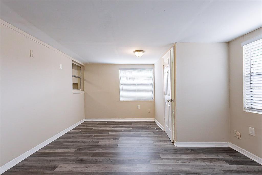8528 Gold Ridge Circle Tampa, FL 33619 - Photo 23 of 31 a view of an empty room with wooden floor and a window
