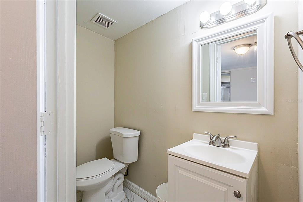 8528 Gold Ridge Circle Tampa, FL 33619 - Photo 24 of 31 a bathroom with a toilet sink vanity and mirror