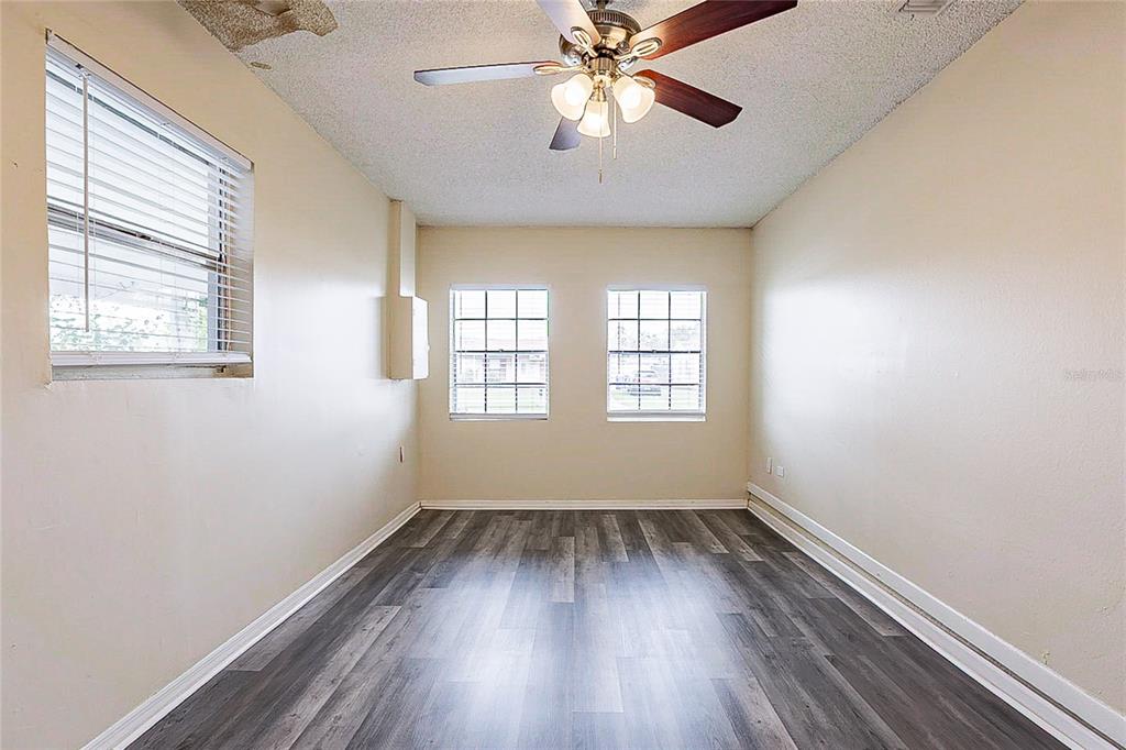 8528 Gold Ridge Circle Tampa, FL 33619 - Photo 25 of 31 wooden floor in an empty room with a window